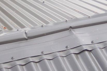 Photograph showing flashing buckling due to timber shrinkage.